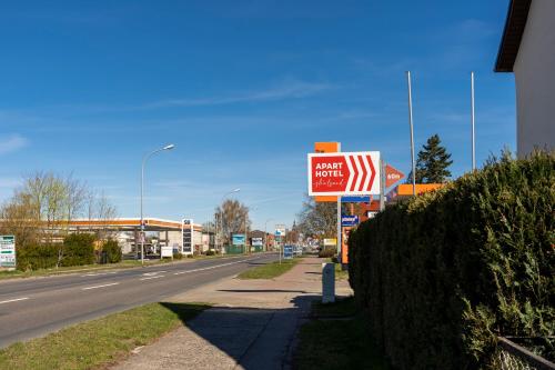 a sign for a store on the side of a road at Aparthotel Stralsund Studios und Apartments in Stralsund