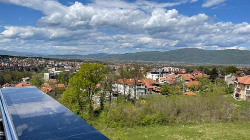 a view of a city from the roof of a house at IN LUX SPA APARTMAN in Vrnjačka Banja
