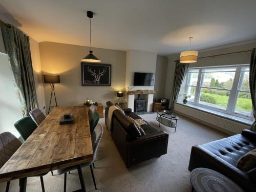 a living room with a table and a couch at Lords Seat in Keswick