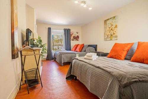 a living room with two beds and a couch at Domaine de l'Aufrene in Hyères