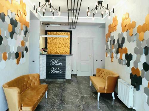 a salon with two chairs and a sign on the wall at White House in Bălţi