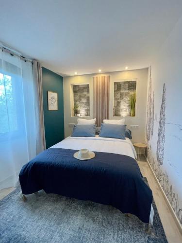 a bedroom with a large bed with a hat on it at Bastide Beaudinard in Aubagne