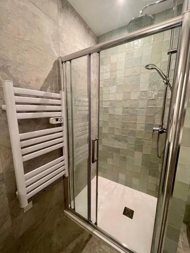 a shower with a glass door in a bathroom at Bastide Beaudinard in Aubagne