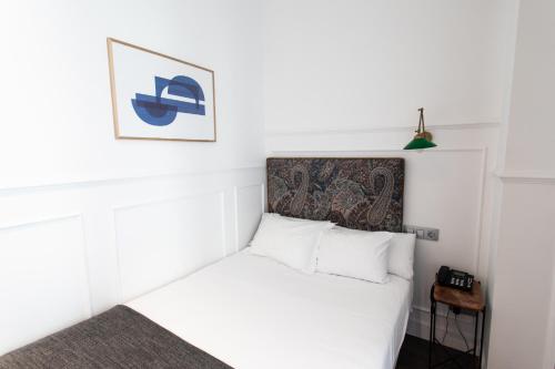 Ένα ή περισσότερα κρεβάτια σε δωμάτιο στο Hotel Trueba