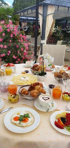 a table topped with plates of food and pastries at Eden Hotel in Bad Krozingen