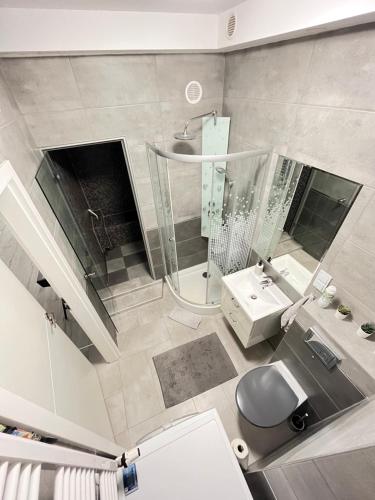 an overhead view of a bathroom with a shower and a sink at Apartament Spa - sauna i garaż w cenie in Ełk