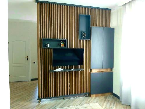 a room with a wall with a television in it at White House in Bălţi