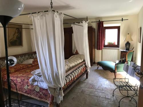 a bedroom with a bed with a canopy at B&b La Baronata - Pescosansonesco (Pe) in Pescosansonesco