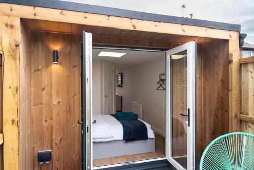 a large sliding glass door opens up to a bedroom at The Garden House in Shrewsbury