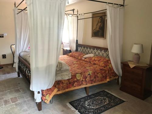 a bedroom with a bed with a canopy at B&b La Baronata - Pescosansonesco (Pe) in Pescosansonesco
