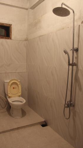 a bathroom with a shower with a toilet in it at sinharaja Aranuwa resort in Nelluwa