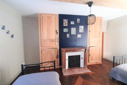 a room with a fireplace and a wooden cabinet at SVB11 "Le GAMILOU" charmante longère rénovée in Boismont