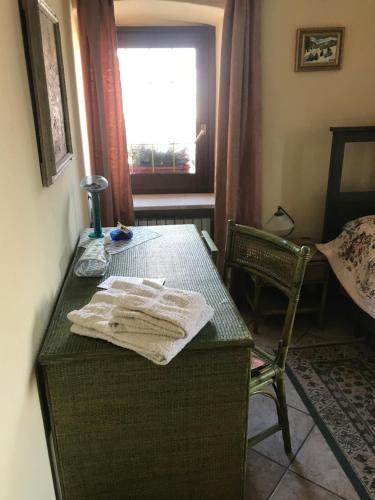 a room with a table with a chair and a window at B&b La Baronata - Pescosansonesco (Pe) in Pescosansonesco