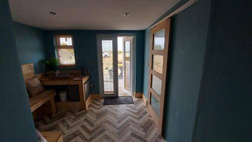 a room with a hallway with a door and a desk at Seals Bacton in Bacton