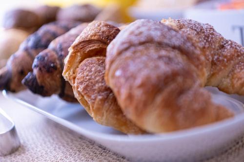 a plate of pastries sitting on a table at B&B Le Sorelle in San Leone