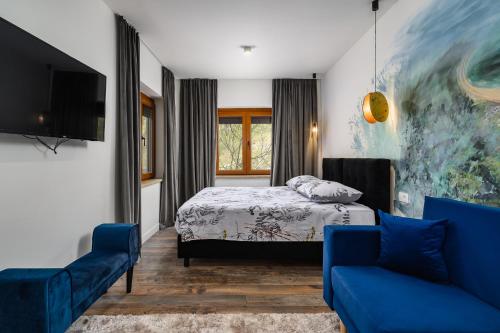 a bedroom with a bed and a tv and a couch at Ponte Porton Dining & lodging in Grožnjan