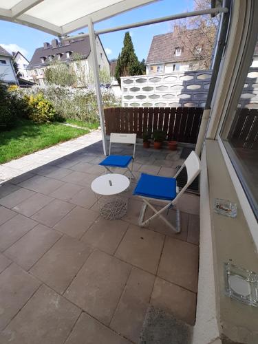 a patio with two chairs and a table at Pension Rückert in Kassel