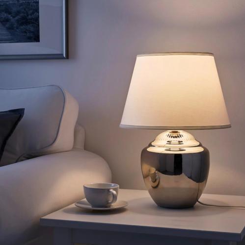 a lamp sitting on a table next to a coffee cup at Seeblick Millstatt in Millstatt