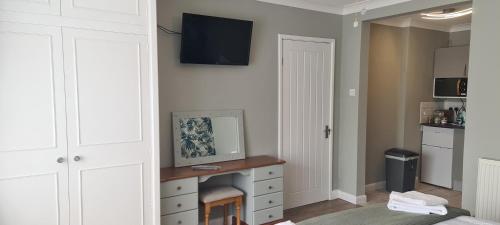a bedroom with a fireplace and a tv on the wall at The Golf Studio Woodhall Spa in Woodhall Spa