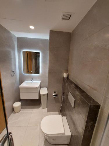 a bathroom with a toilet and a sink at Luxury Studio - Damac Tower Amman in Amman