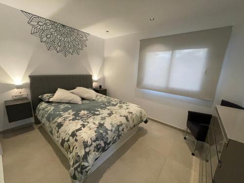 a bedroom with a bed and a window at Chalet del Sol en El Faro in Mijas Costa
