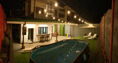 a house with a swimming pool at night at Casa Leyenda in Arbolito