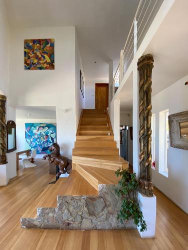 a staircase in a house with a stone pillar at Tunquen Magico in Tunquen