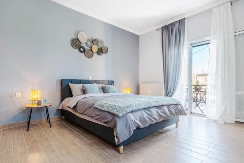 a bedroom with a bed and a table and a window at Eftychia's Garden House in Kompítsion