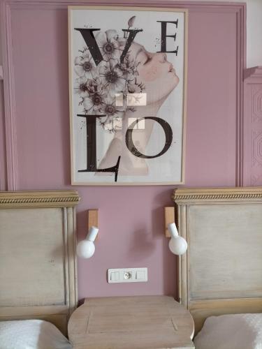 a picture of a letter k on a wall above two beds at Hotel Casona del Sella in Arriondas