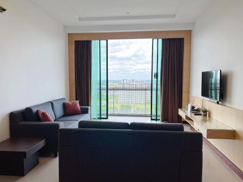 a living room with a couch and a large window at Imperial Grand Suite Apartment At Boulevard Kuching in Kuching