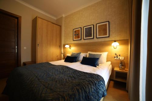 a hotel room with a large bed with two pillows at Portal House Apartments in Kraków