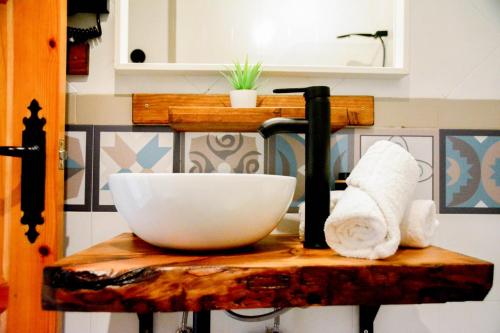 a white bowl on top of a wooden table at Apartamentos Vista Veleta in Capileira