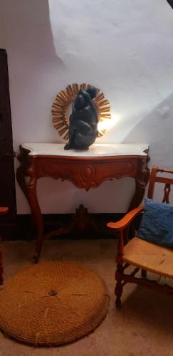 a table with a lion statue on it next to a chair at Castell Granadella in L'Ampolla