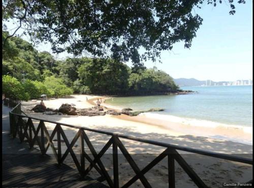 a beach with a fence next to the water at Flat Prédio Frente MAR in Balneário Camboriú