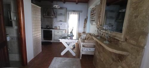 a kitchen with a counter and a sink in a room at Elouthia Residence with Sea View and Hot Tub in Tsoútsouros