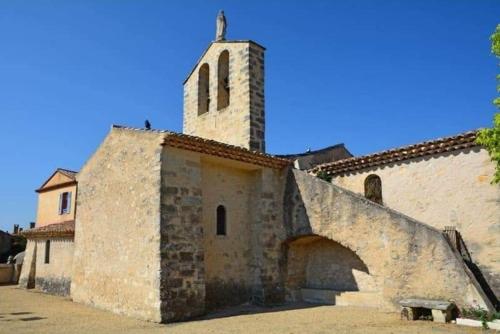 an old building with a tower and a bridge at Gîte d'étape de Vitrolles en Luberon in Vitrolles-en-Luberon