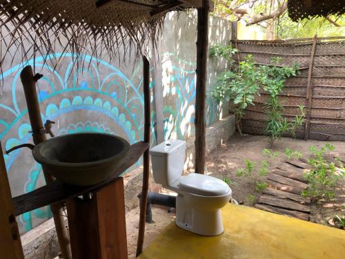 a bathroom with a sink and a toilet at Margarita Village kite school kalpitiya in Kalpitiya