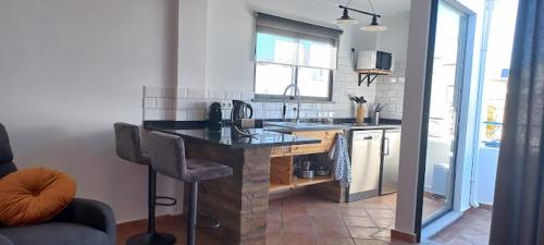 a kitchen with a island in the middle of a room at Casa Do Pescador in Olhão