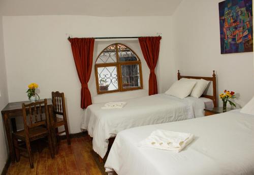 Postel nebo postele na pokoji v ubytování Posada Catama INN