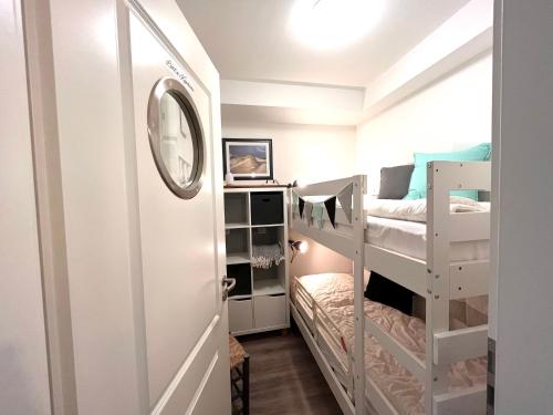 a room with two bunk beds and a mirror at Beach54 Damp Wellness-Loft in Damp