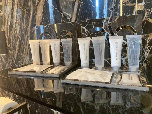 a display of toothbrushes and glasses on a glass shelf at Tiny House - Luxury Cottage in Bullange
