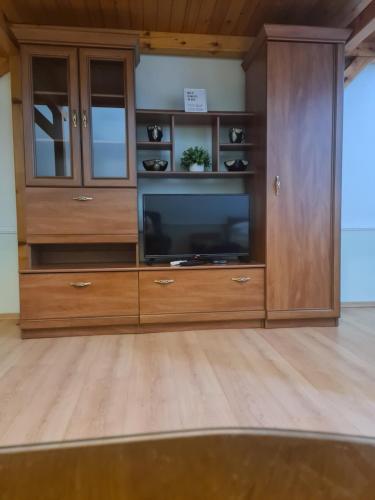 a large wooden entertainment center with a flat screen tv at Siesta in Kikinda