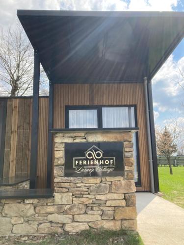 a building with a sign in front of it at Tiny House - Luxury Cottage in Bullange
