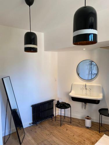 a bathroom with a sink and a mirror at MY BOUTIQUE GUESTHOUSE - Fabulous Suites 10 Min A7 - in Anneyron