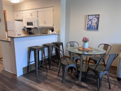 a kitchen with a table and chairs and a refrigerator at Homestead Suites - Fish Creek in Fish Creek