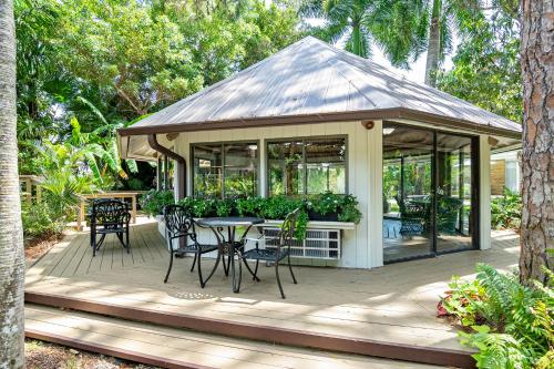 a gazebo with a table and chairs on a deck at The Fairways Inn of Naples in Naples