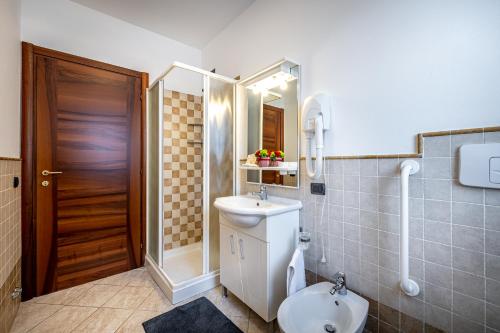 a bathroom with a toilet and a sink and a shower at Casa Vacanze Arianna in Rosia