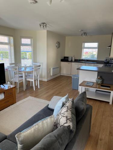 a living room with a couch and a table at Corran, Glenloch View, Fort William 2-Bedroom Loch Side Flat in Fort William