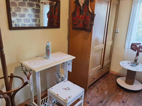 a room with a table and two vases on it at Etno kuća Parče neba in Užice