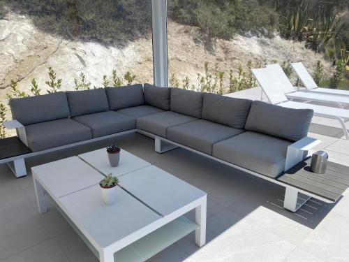 a blue couch sitting on a patio with a table at Il Mare di Giù Boutique Guesthouse in Licata